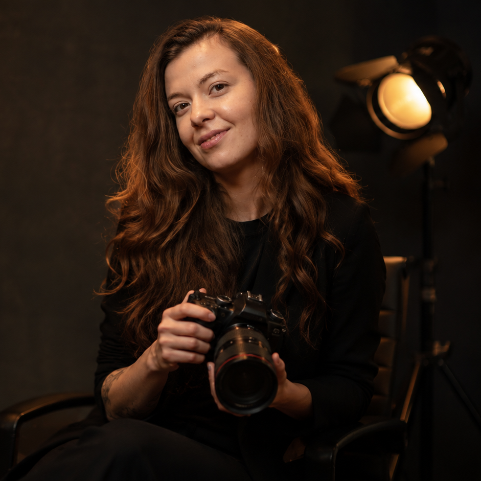 Bianca, portrait photographer, holding her camera inside her private Dublin 22 photography studio